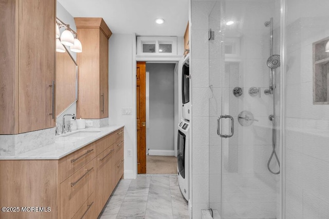 8 Eunice Ter, West Long Branch, NJ 07764 - full bath featuring a stall shower, stacked washer and clothes dryer, vanity, marble look tiles, and recessed lighting