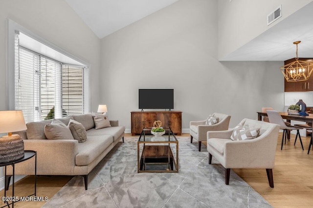 8 Eunice Ter, West Long Branch, NJ 07764 - living area with light wood-type flooring, high vaulted ceiling, and a chandelier