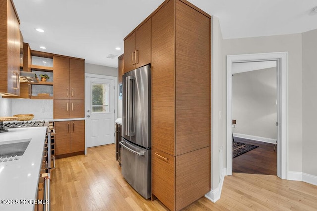 8 Eunice Ter, West Long Branch, NJ 07764 - kitchen featuring high quality fridge, brown cabinetry, light wood-style flooring, open shelves, and recessed lighting