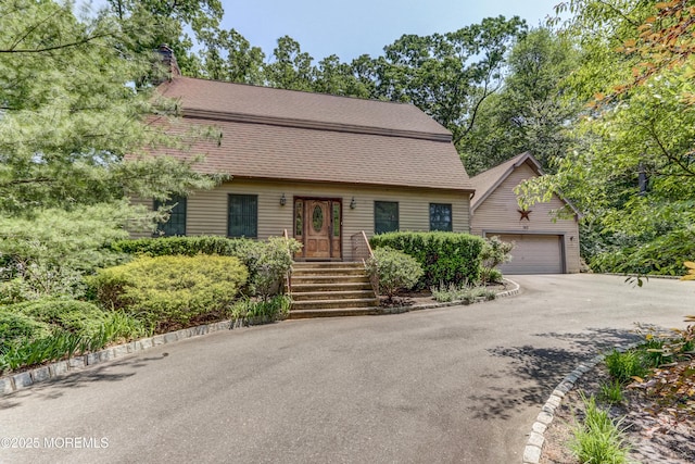 143 Siloam Rd, Freehold, NJ 07728 - view of front facade featuring asphalt driveway, an outbuilding, and a garage