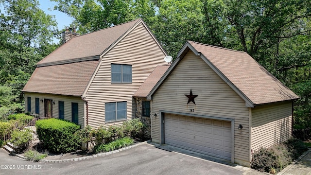 143 Siloam Rd, Freehold, NJ 07728 - view of front of home featuring a chimney, a shingled roof, and a detached garage