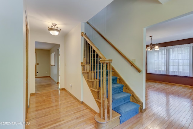 143 Siloam Rd, Freehold, NJ 07728 - stairs with wood-type flooring and a chandelier
