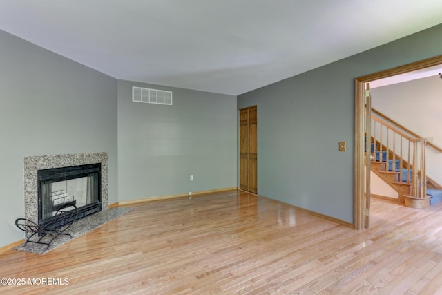 143 Siloam Rd, Freehold, NJ 07728 - unfurnished living room featuring wood finished floors, stairway, and a fireplace