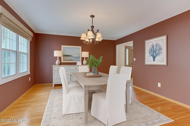 143 Siloam Rd, Freehold, NJ 07728 - dining area with a chandelier, light wood finished floors, and crown molding