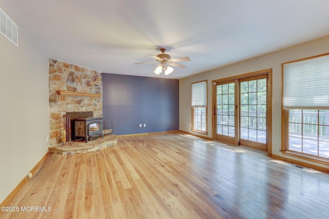 143 Siloam Rd, Freehold, NJ 07728 - unfurnished living room with wood finished floors, ceiling fan, and a wood stove