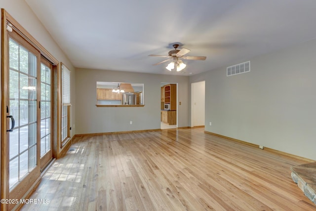 143 Siloam Rd, Freehold, NJ 07728 - spare room with a chandelier, light wood-style flooring, and a ceiling fan