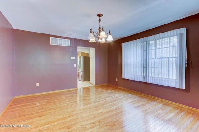 143 Siloam Rd, Freehold, NJ 07728 - empty room with a chandelier and wood finished floors