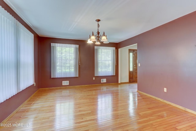 143 Siloam Rd, Freehold, NJ 07728 - spare room with a chandelier and light wood finished floors