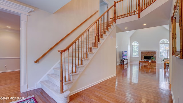 88 Vanderveer Dr, Basking Ridge, NJ 07920 - staircase with a towering ceiling, wood finished floors, a fireplace, and recessed lighting