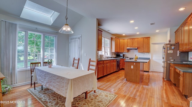 88 Vanderveer Dr, Basking Ridge, NJ 07920 - kitchen featuring a center island, healthy amount of natural light, dark countertops, light wood-type flooring, and vaulted ceiling