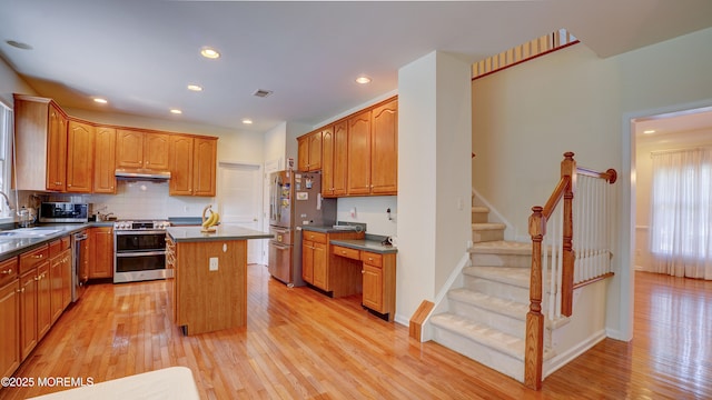 88 Vanderveer Dr, Basking Ridge, NJ 07920 - kitchen with appliances with stainless steel finishes, under cabinet range hood, a center island, light wood-style flooring, and recessed lighting