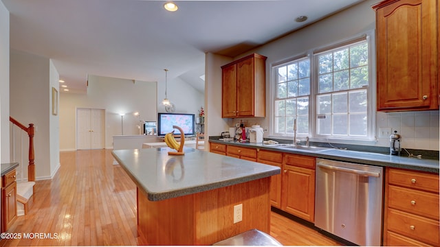 88 Vanderveer Dr, Basking Ridge, NJ 07920 - kitchen with stainless steel dishwasher, a kitchen island, light wood-type flooring, dark countertops, and brown cabinetry