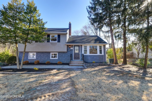 42 Cherry Tree Farm Rd, Middletown, NJ 07748 - tri-level home featuring a chimney and stone siding