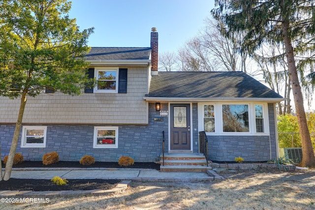 42 Cherry Tree Farm Rd, Middletown, NJ 07748 - split level home featuring stone siding, a chimney, and roof with shingles