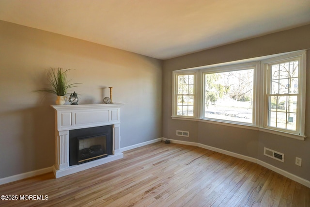 42 Cherry Tree Farm Rd, Middletown, NJ 07748 - unfurnished living room featuring light wood-style floors and a fireplace