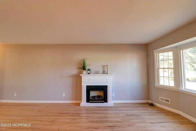 42 Cherry Tree Farm Rd, Middletown, NJ 07748 - unfurnished living room with light wood finished floors and a fireplace with raised hearth