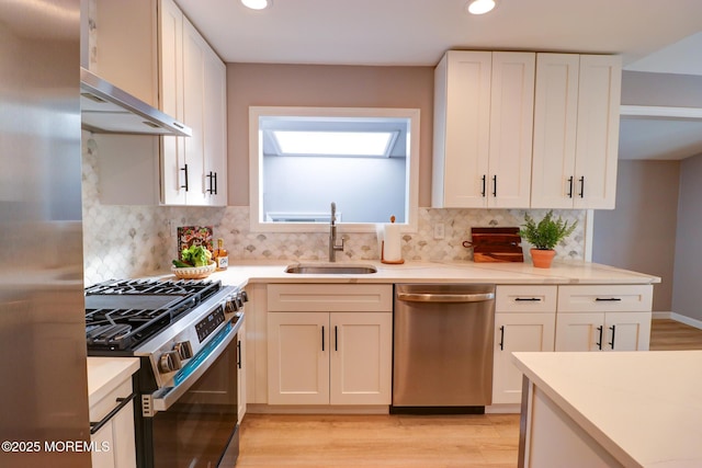 42 Cherry Tree Farm Rd, Middletown, NJ 07748 - kitchen with stainless steel appliances, wall chimney exhaust hood, recessed lighting, light wood finished floors, and backsplash