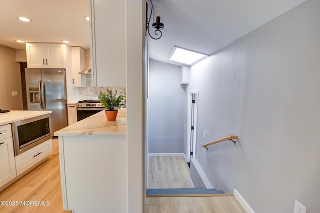 42 Cherry Tree Farm Rd, Middletown, NJ 07748 - kitchen with stainless steel appliances, light wood-style floors, white cabinetry, backsplash, and recessed lighting