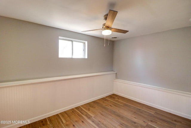 42 Cherry Tree Farm Rd, Middletown, NJ 07748 - unfurnished room with a ceiling fan, wood finished floors, and a wainscoted wall