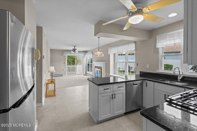 50 Normanton Ave, Manchester, NJ 08759 - kitchen featuring stainless steel appliances, a ceiling fan, a peninsula, open floor plan, and dark stone countertops