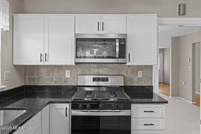50 Normanton Ave, Manchester, NJ 08759 - kitchen featuring appliances with stainless steel finishes, white cabinets, and dark stone counters
