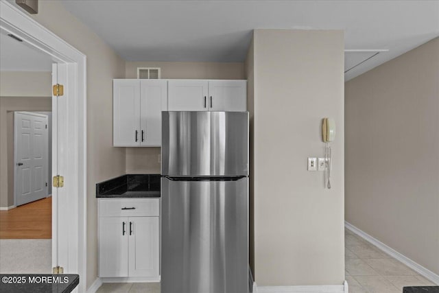 50 Normanton Ave, Manchester, NJ 08759 - kitchen featuring freestanding refrigerator, white cabinets, dark countertops, and light tile patterned floors