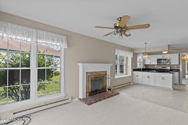 50 Normanton Ave, Manchester, NJ 08759 - unfurnished living room featuring a baseboard heating unit, a fireplace, and a ceiling fan