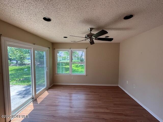 133 Sunnymede St, Englishtown, NJ 07726 - empty room featuring a textured ceiling, a ceiling fan, and wood finished floors