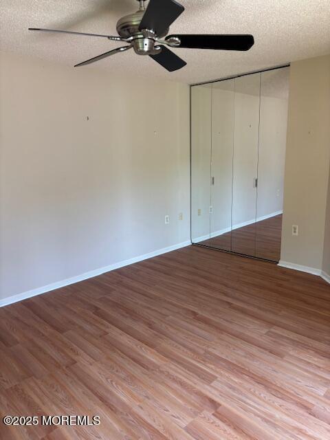 133 Sunnymede St, Englishtown, NJ 07726 - unfurnished bedroom with a textured ceiling, wood finished floors, ceiling fan, and a closet