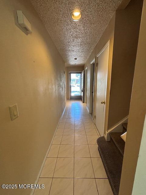 133 Sunnymede St, Englishtown, NJ 07726 - corridor featuring a textured ceiling, light tile patterned floors, stairway, and recessed lighting