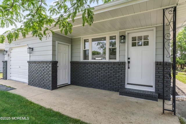696 Jamaica Blvd, Toms River, NJ 08757 - property entrance featuring brick siding, an attached garage, and covered porch