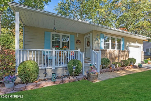 8 Wisconsin Ln, Whiting, NJ 08759 - bungalow-style house with a porch, a front lawn, and an attached garage