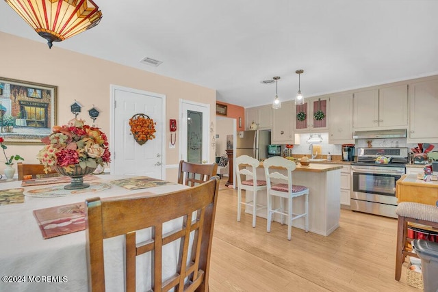 8 Wisconsin Ln, Whiting, NJ 08759 - kitchen with appliances with stainless steel finishes, light countertops, under cabinet range hood, light wood-style floors, and a kitchen island