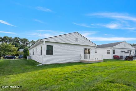 169 Pulaski Blvd, Toms River, NJ 08757 - rear view of house with a lawn and a wooden deck