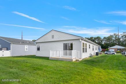 169 Pulaski Blvd, Toms River, NJ 08757 - rear view of house featuring a lawn and a deck