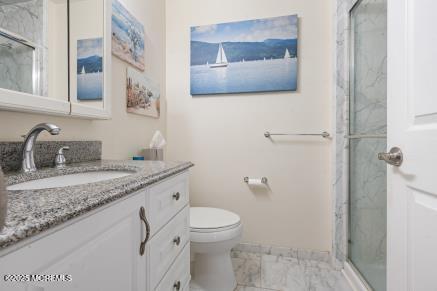 169 Pulaski Blvd, Toms River, NJ 08757 - bathroom featuring vanity, a marble finish shower, and marble finish flooring