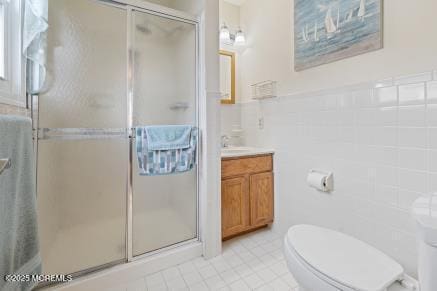 169 Pulaski Blvd, Toms River, NJ 08757 - full bath with vanity, a shower stall, tile walls, and tile patterned flooring