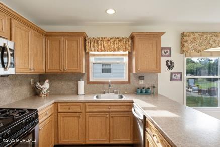 169 Pulaski Blvd, Toms River, NJ 08757 - kitchen featuring appliances with stainless steel finishes, light countertops, backsplash, and recessed lighting