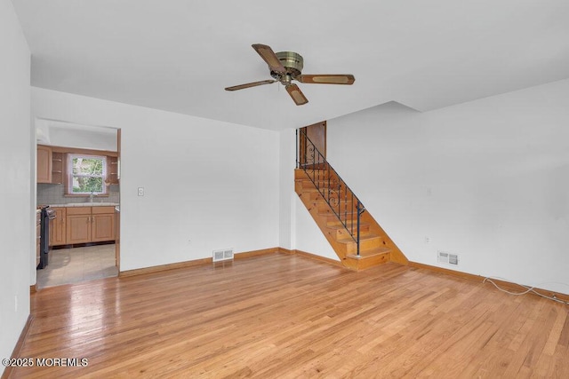 1316 Sunset Ave, Point Pleasant, NJ 08742 - unfurnished living room featuring light wood-style floors, stairway, and a ceiling fan