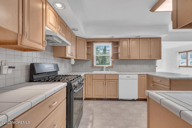 1316 Sunset Ave, Point Pleasant, NJ 08742 - kitchen with dishwasher, black gas range oven, under cabinet range hood, tile countertops, and healthy amount of natural light