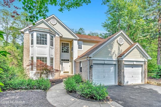 8 Armistead Ky, Colts Neck, NJ 07722 - traditional-style house with brick siding, an attached garage, and driveway