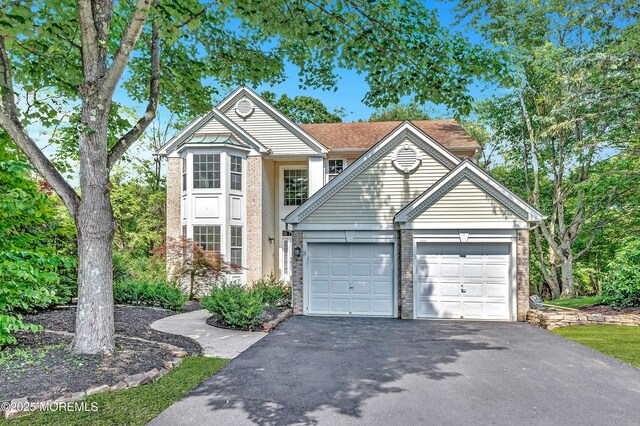 8 Armistead Ky, Colts Neck, NJ 07722 - traditional-style house featuring asphalt driveway, brick siding, and an attached garage