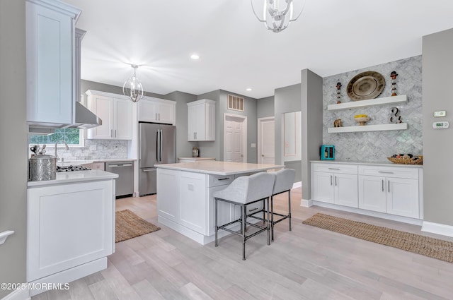 8 Armistead Ky, Colts Neck, NJ 07722 - kitchen with appliances with stainless steel finishes, decorative backsplash, light countertops, a center island, and recessed lighting