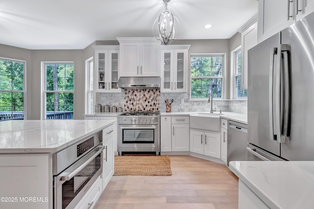 8 Armistead Ky, Colts Neck, NJ 07722 - kitchen featuring appliances with stainless steel finishes, under cabinet range hood, white cabinetry, decorative backsplash, and recessed lighting