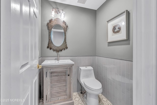 8 Armistead Ky, Colts Neck, NJ 07722 - bathroom featuring vanity, a wainscoted wall, tile patterned flooring, and tile walls
