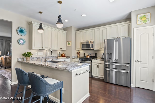 126 Waypoint Dr, Eatontown, NJ 07724 - kitchen with appliances with stainless steel finishes, recessed lighting, dark wood-style floors, a peninsula, and light stone countertops