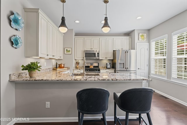 126 Waypoint Dr, Eatontown, NJ 07724 - kitchen with appliances with stainless steel finishes, dark wood finished floors, a peninsula, pendant lighting, and recessed lighting