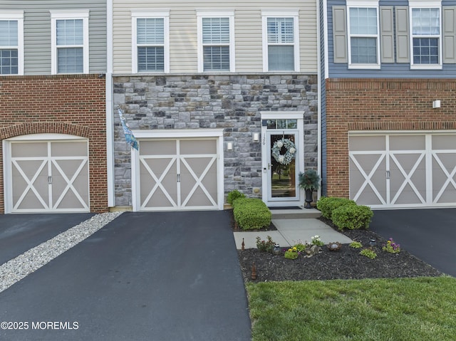 126 Waypoint Dr, Eatontown, NJ 07724 - view of front of house featuring driveway, a garage, and stone siding