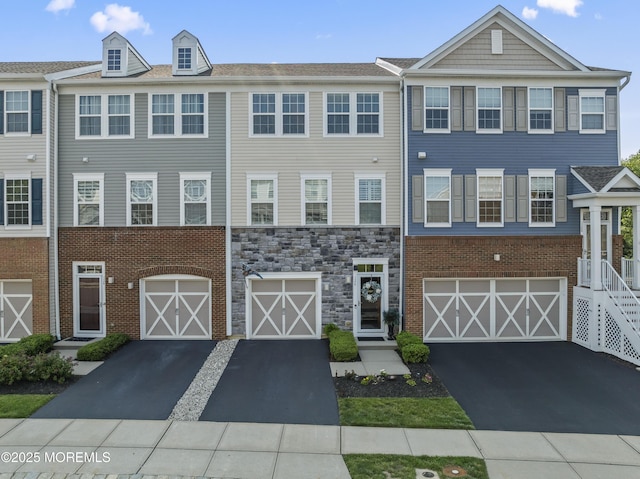 126 Waypoint Dr, Eatontown, NJ 07724 - multi unit property featuring driveway, a garage, and stone siding