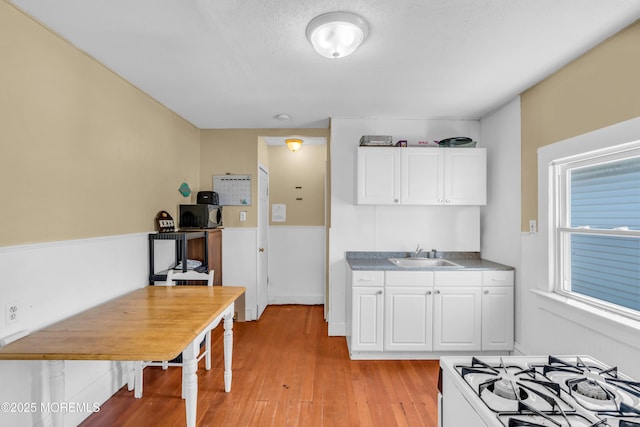 1103 A St, Belmar, NJ 07719 - kitchen with white gas stove, light wood finished floors, and white cabinetry